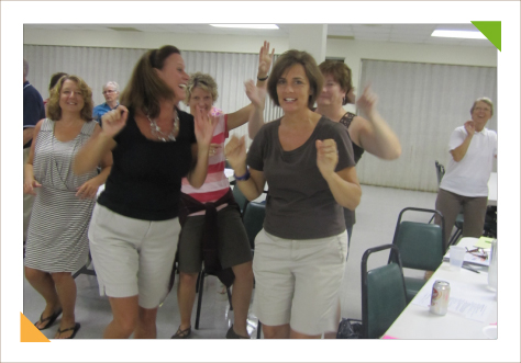Audience of teachers interacting with educational consulting expert Kim Hughes during teacher training workshops