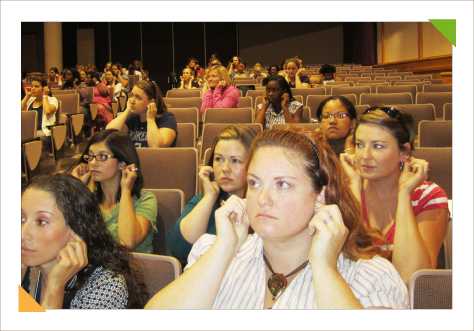 Audience of teachers learning classroom teaching strategies from educational consulting expert Kim Hughes during teacher training workshops