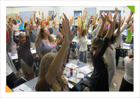 Audience of teachers interacting with educational consulting expert Kim Hughes during teacher training workshops