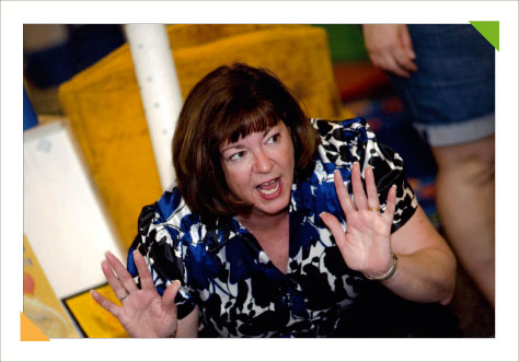 Educational consulting experting expert Kim Hughes engages the attention of a group of teachers